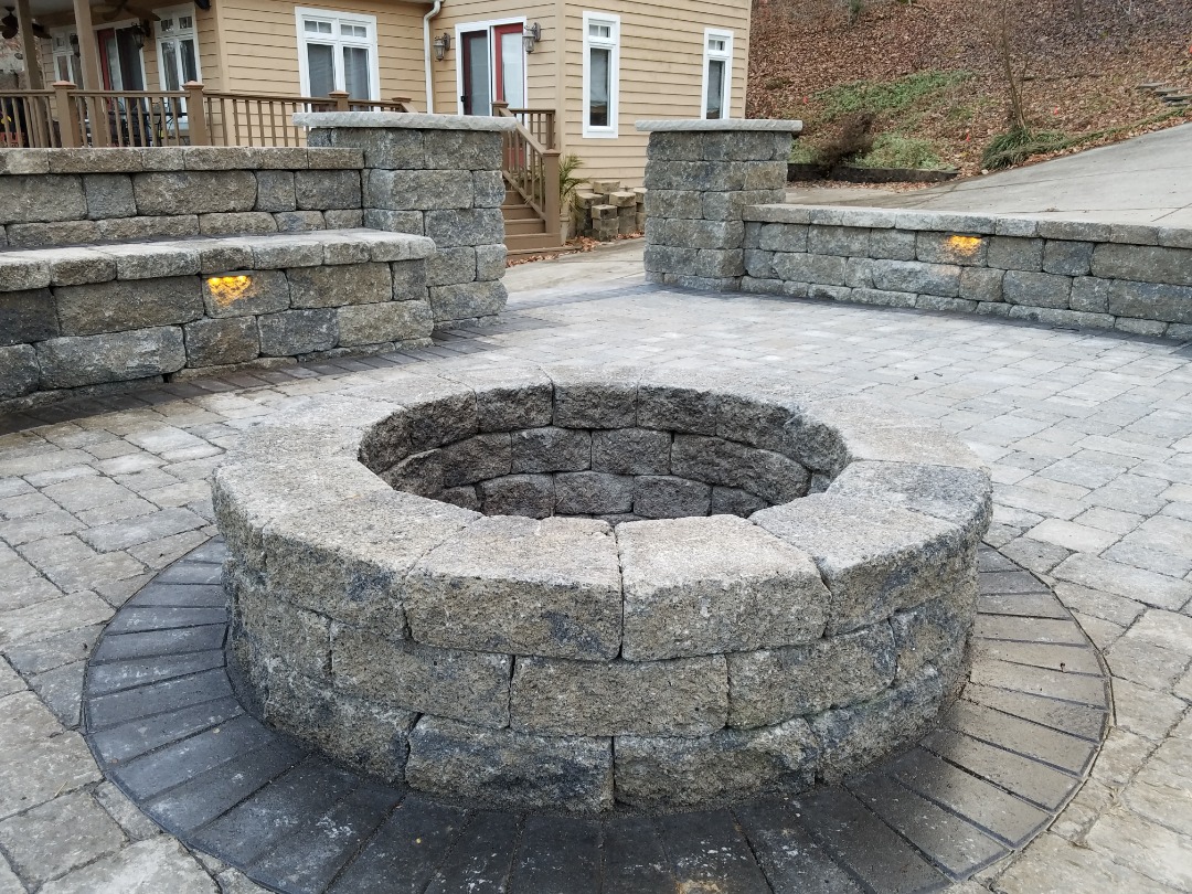 A well constructed patio with a fire pit to match.