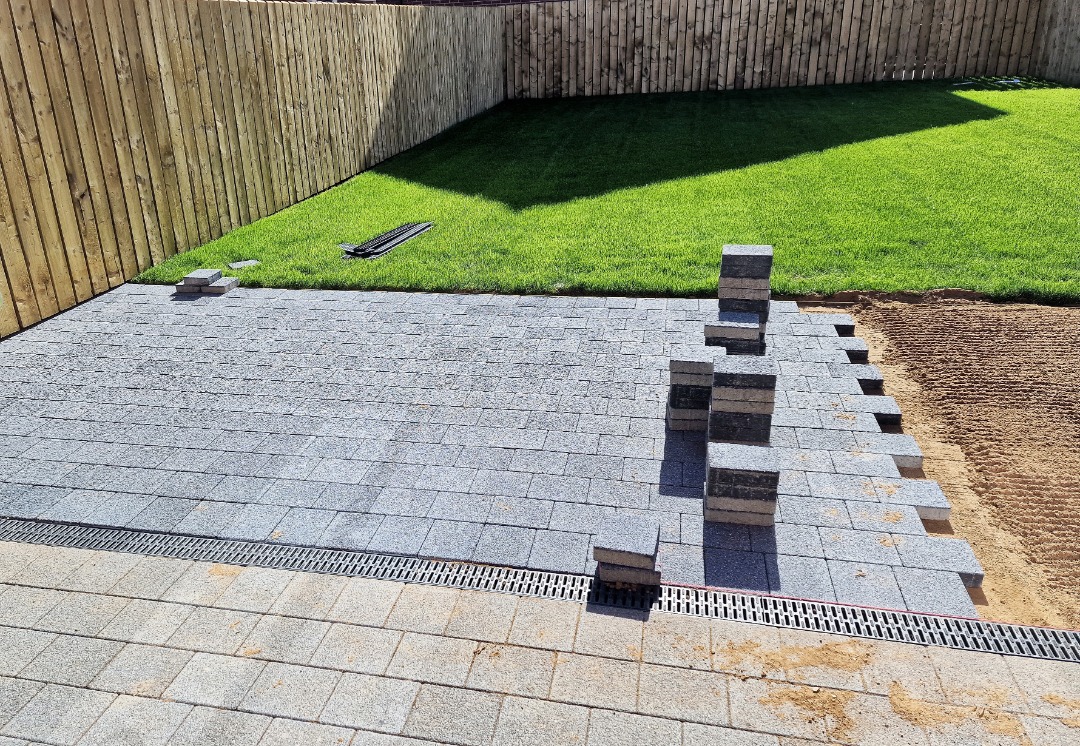 goperfection-Pavers-Greenville Experts in the middle of laying down a grey paver patio.